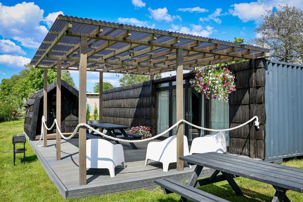 a tiny house with a hammock on a deck at ''Zunds'' Camping house in Riga