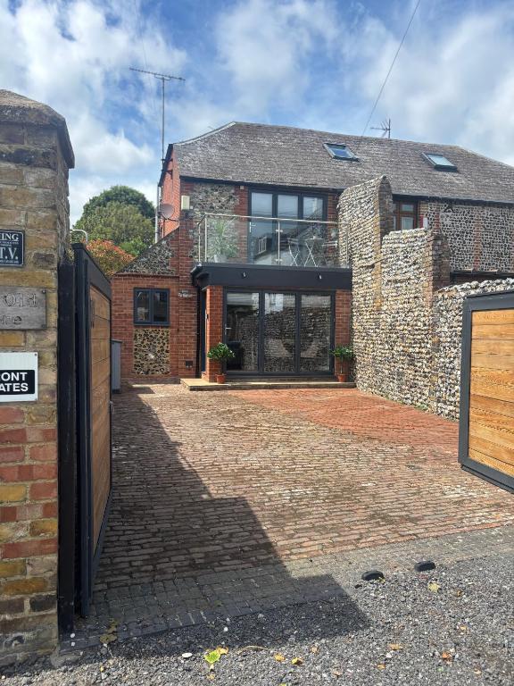 a brick house with a brick driveway in front of it at Small and Snug The Old Store in Broadstairs