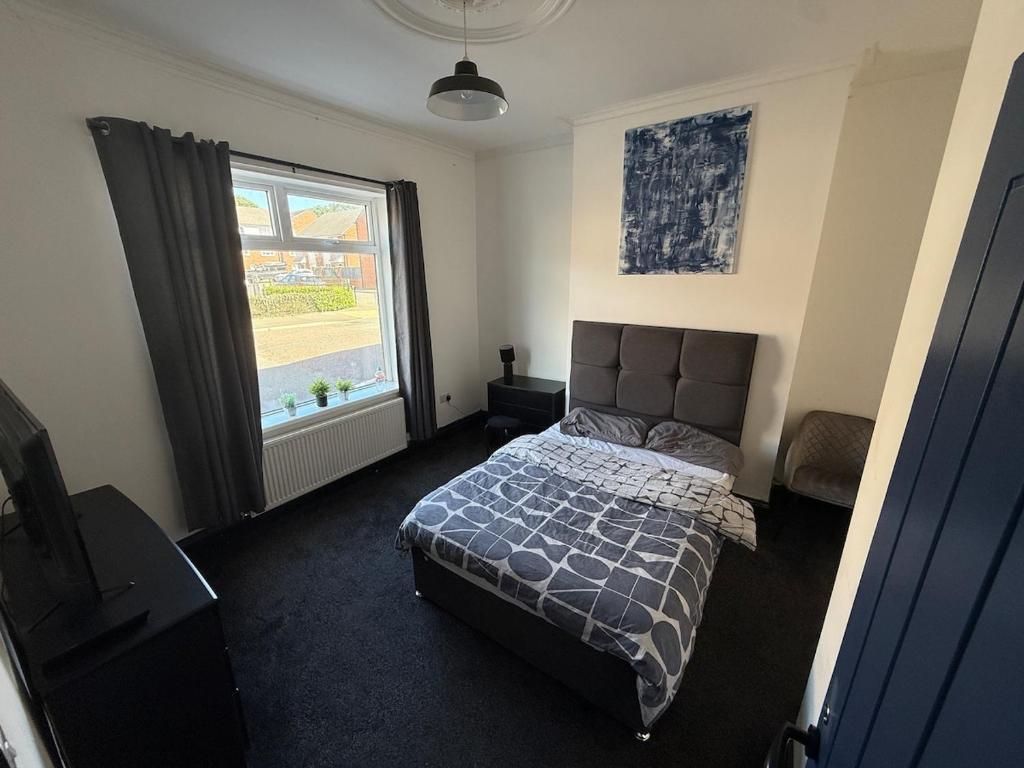 a bedroom with a bed and a large window at Plessey Road LARGE 5 Bed, 2 Bath, Contractors NEW in Cowpen