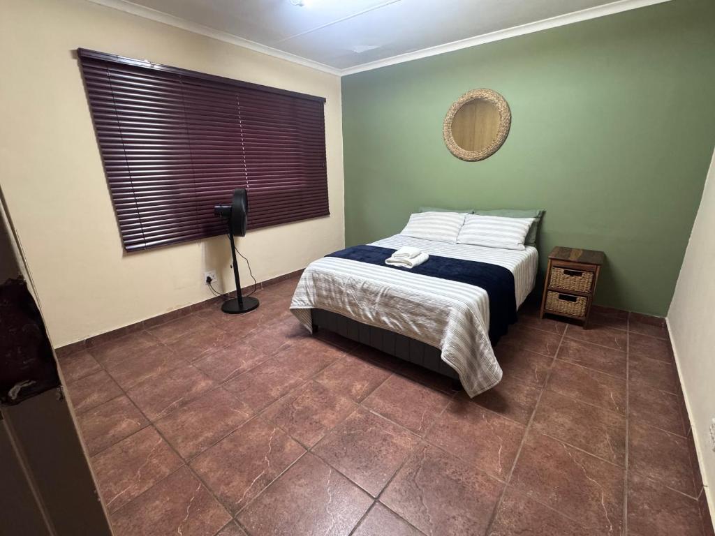 a bedroom with a bed and a window at Kalahari Hotel in Olifantshoek