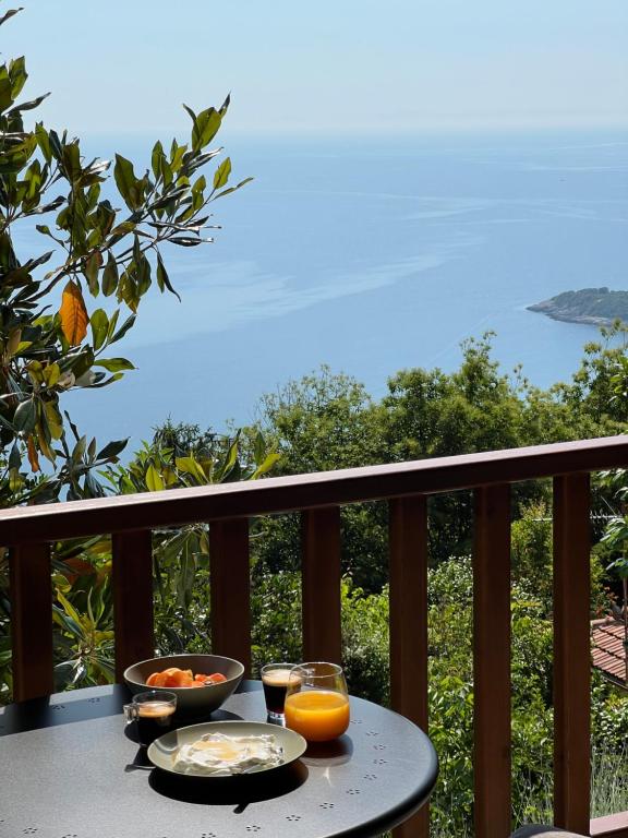 a table with two plates of food on a balcony at Om Living Pelion in Agios Dimitrios
