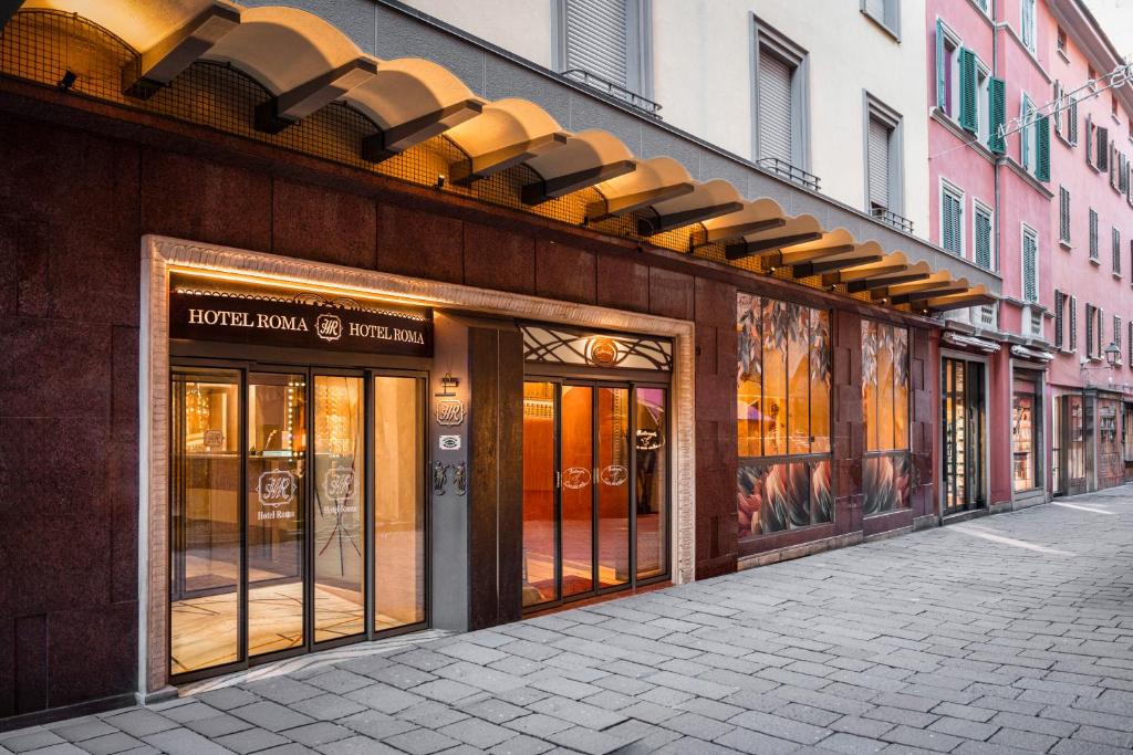 a store front with glass doors on a street at Hotel Roma in Bologna
