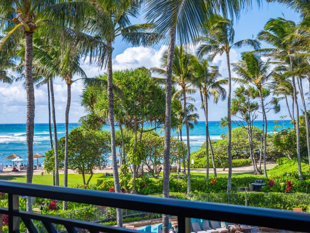 a view from the balcony of a resort with palm trees at 3-Bed Villa 309 at Turtle Bay in Kahuku