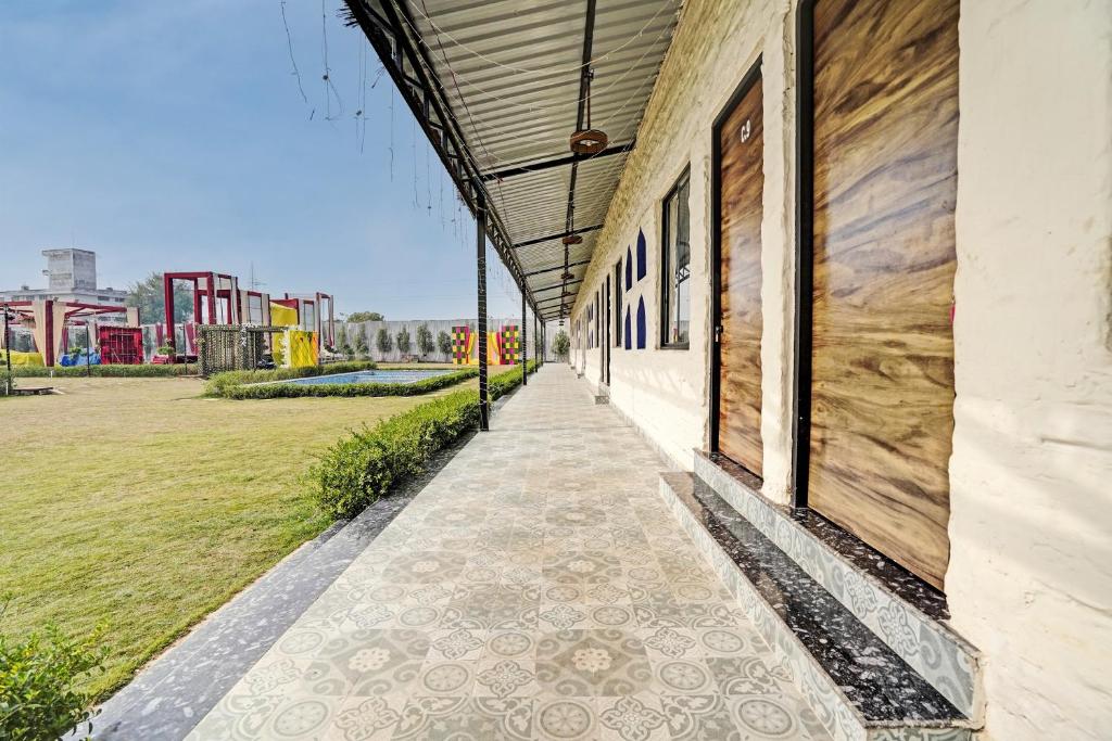 a walkway next to a building with a playground at Hotel O New Friends Hotel in Prayagraj