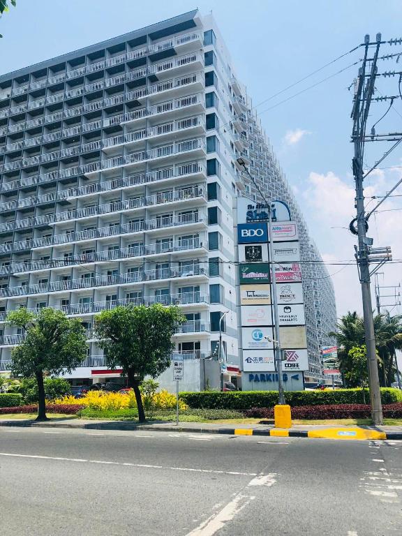 a large building with signs in front of it at Accommodating Place in Manila