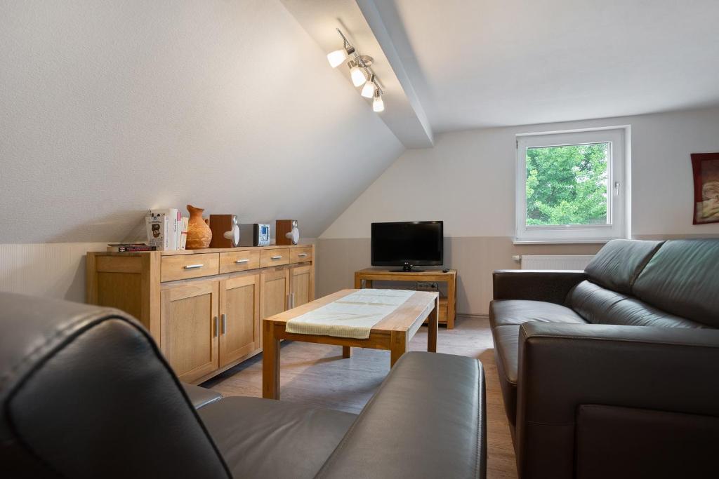 a living room with a couch and a table at Ferienwohnung 1 in Gribow