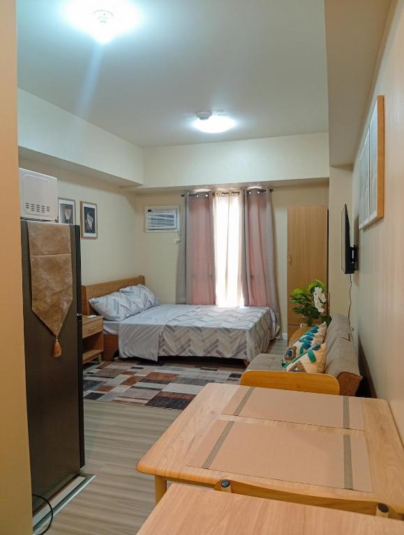 a small room with two beds and a table at Avida Towers Riala, Tower 5 in Cebu City