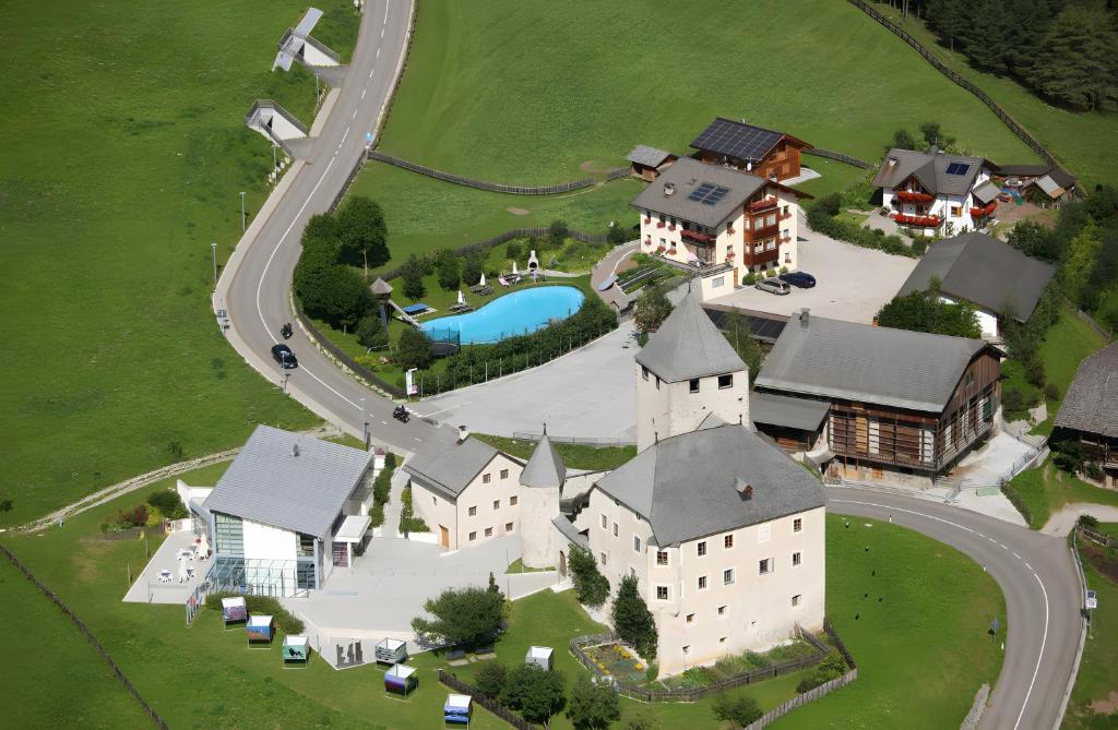 an aerial view of a house with a church at Lüch de Tor in San Martino in Badia