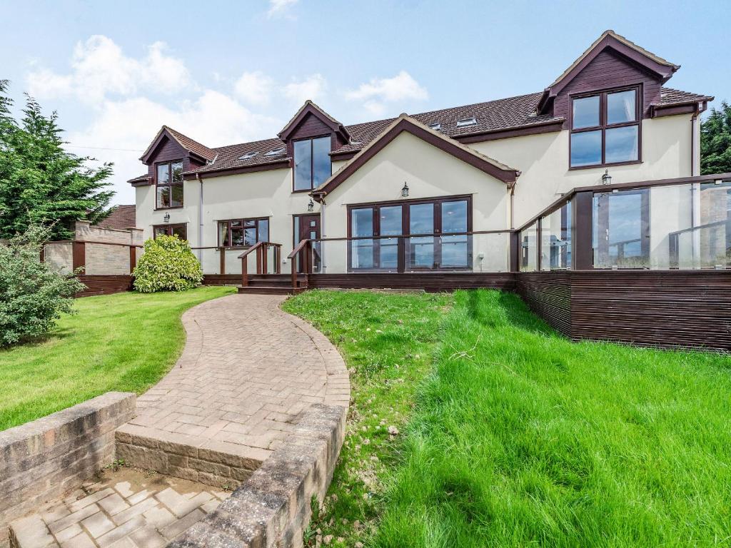 a large white house with a walkway at Paradise in Cinderford