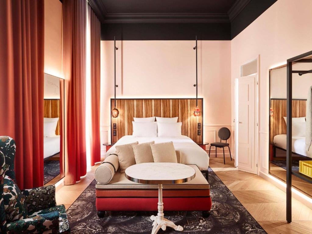a hotel room with a bed and a table at Mama Shelter Rennes in Rennes