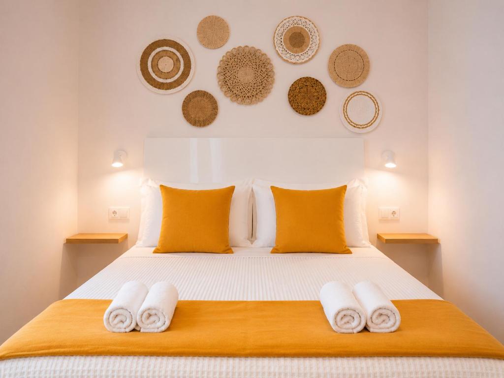 a bedroom with a bed with towels on it at Social Lodge Cabouqueira Studios in Funchal