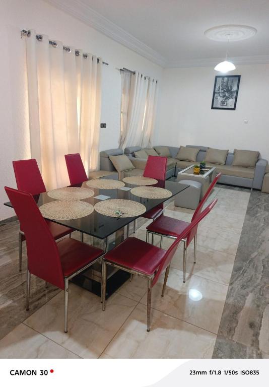 a living room with a table and chairs and a couch at Baie des Anges in Lomé