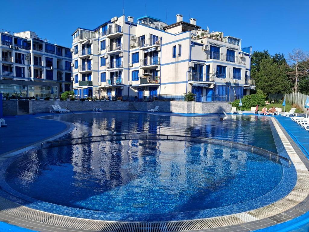 a large swimming pool in front of some buildings at Студио C19 в к-с Blue Bay Palace in Pomorie