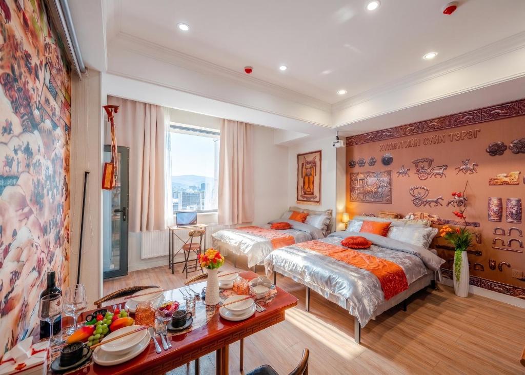 a bedroom with two beds and a table with plates on it at Ulaanbaatar Heritage Stay in Ulaanbaatar
