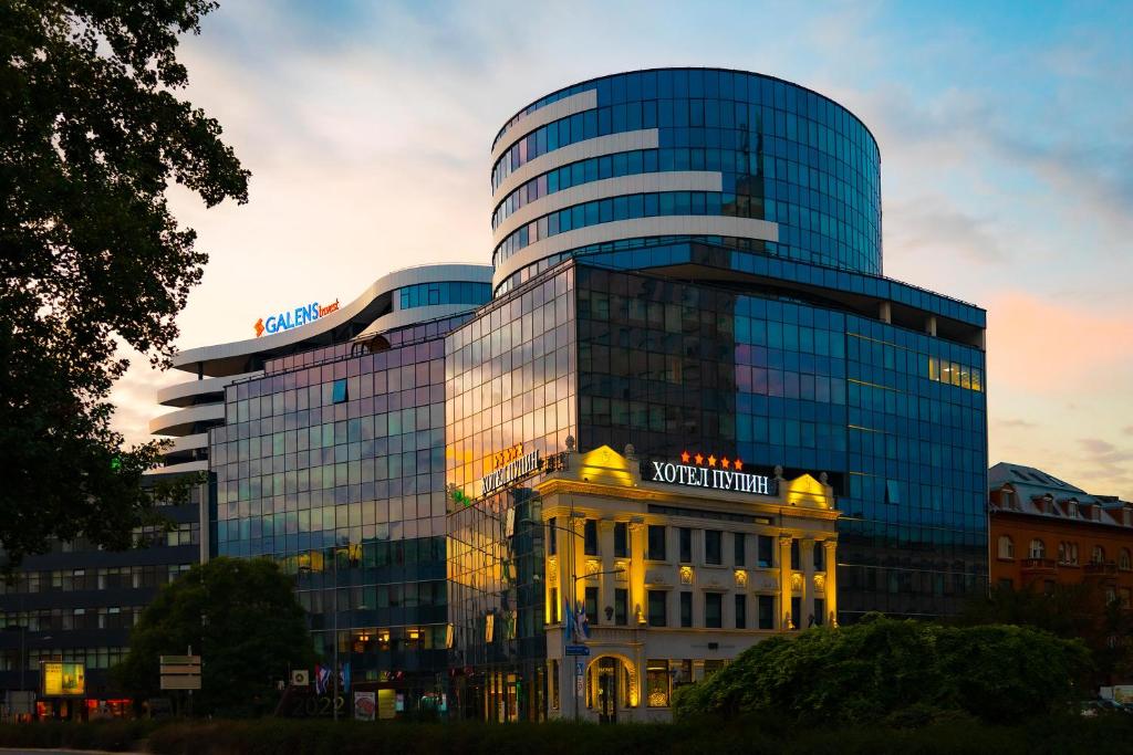 a building with a sign on the side of it at Hotel Pupin Novi Sad in Novi Sad