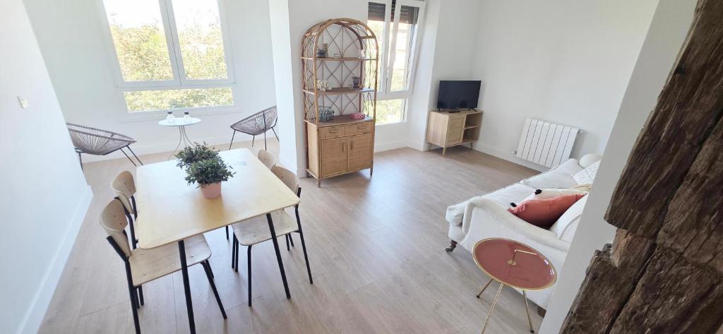 a living room with a table and a couch at Sand House Gorliz By Kima Gestión in Górliz-Elexalde