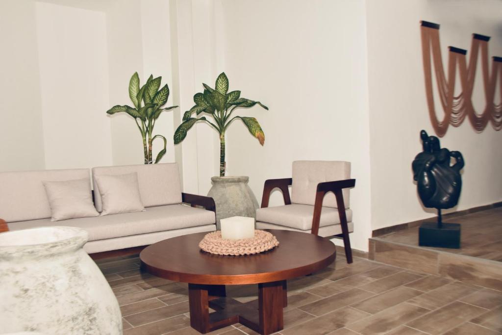 a living room with a couch and a table at Paraíso maya apartaments in Playa del Carmen