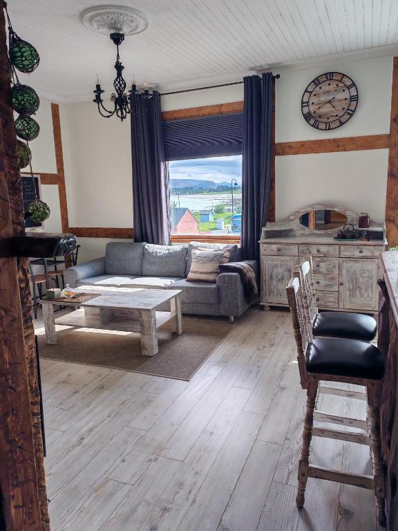 a living room with a couch and a table at Timber loft in Vigra