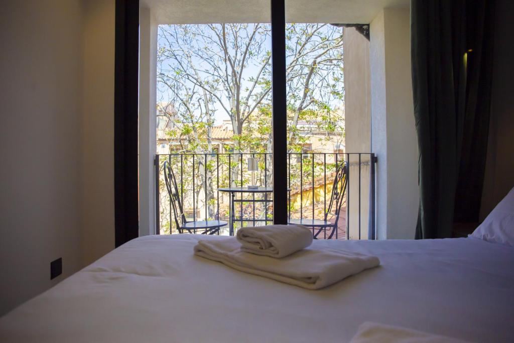 a bedroom with a bed with a view of a balcony at Solemar Sicilia - Torre Maqueda in Palermo