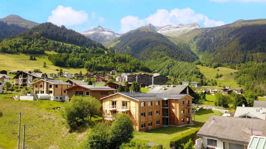 a village in a valley with mountains in the background at Residenza Pazzola in Disentis