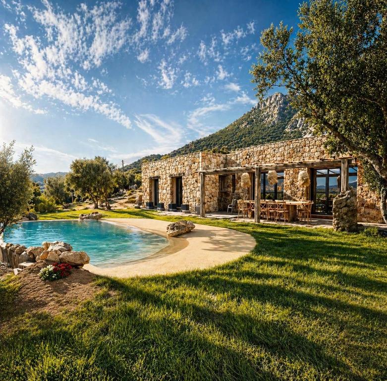 a stone house with a pool in the yard at Casa Campo Longo in Belgodère