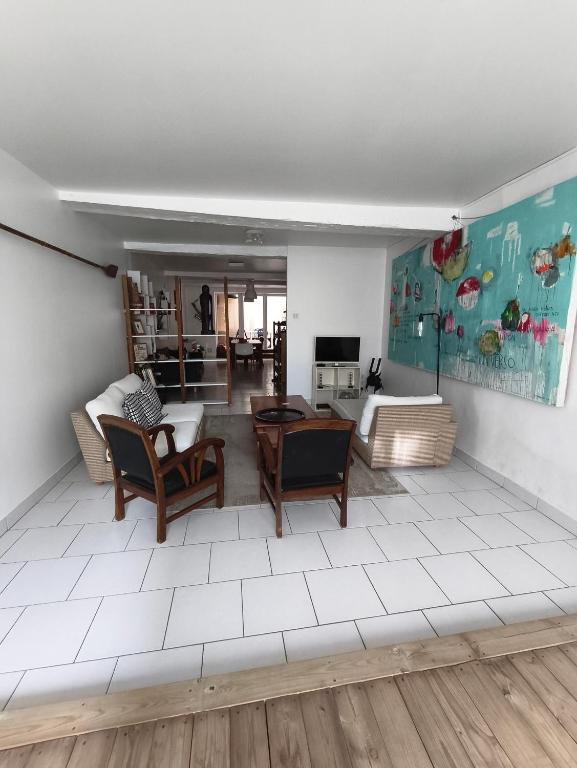 a living room with a couch and a table at Chez Marie, maison ArtY in Lauzun