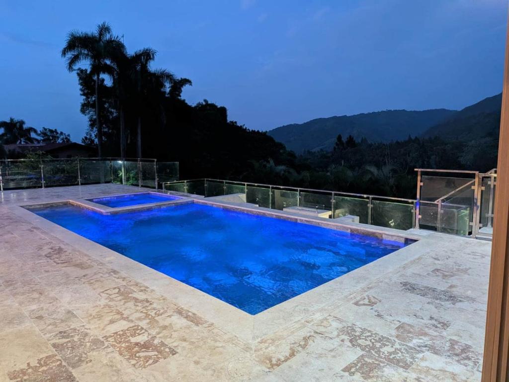 a large swimming pool with a view of the mountains at Brisal Mountain Retreat in Jarabacoa