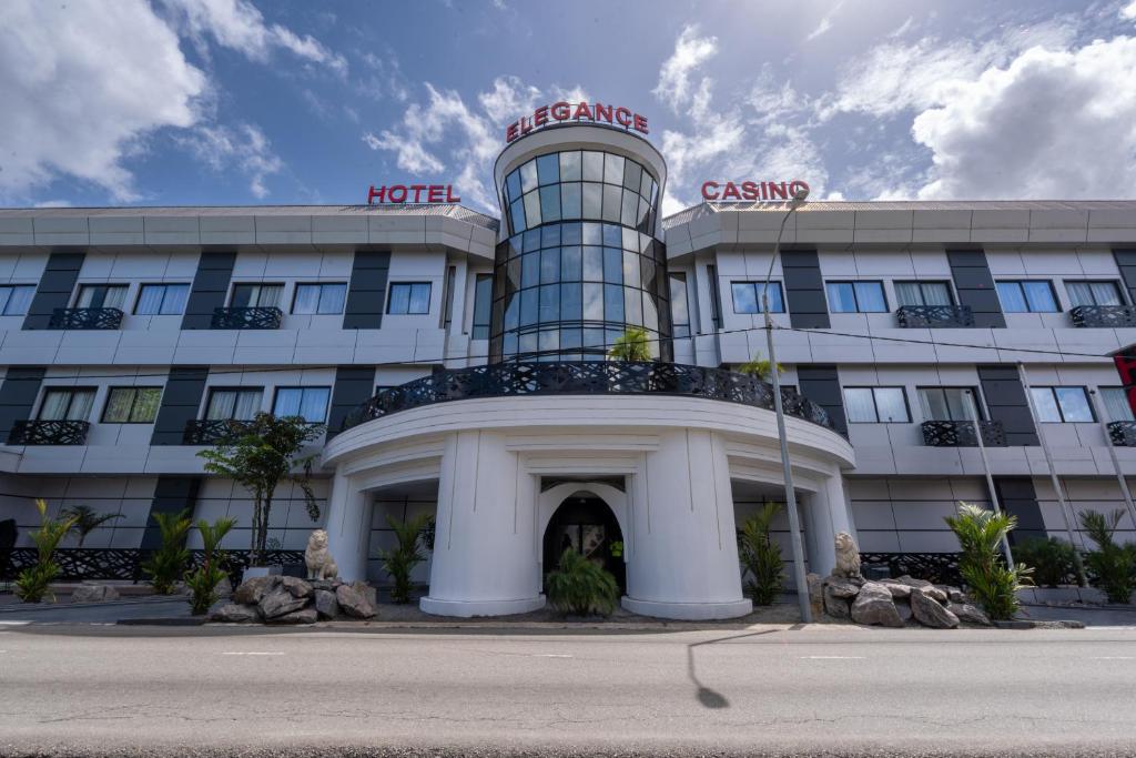 a hotel building with a sign on top of it at Hotel Elegance NV in Paramaribo