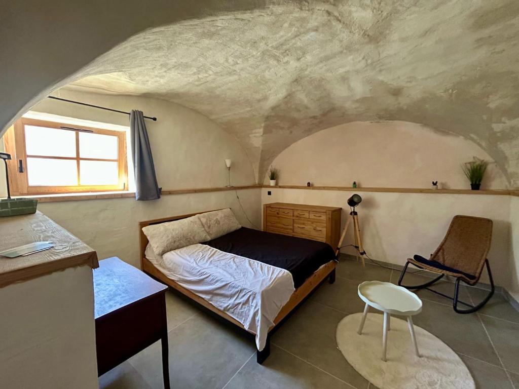 a bedroom with a bed and a desk and a chair at Studio le Replat in Aime-La Plagne