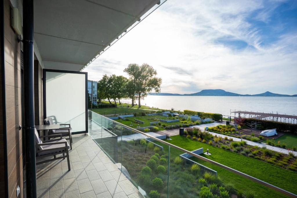 a balcony with a view of the water at Sunset Resort 116 Lakeview in Fonyód