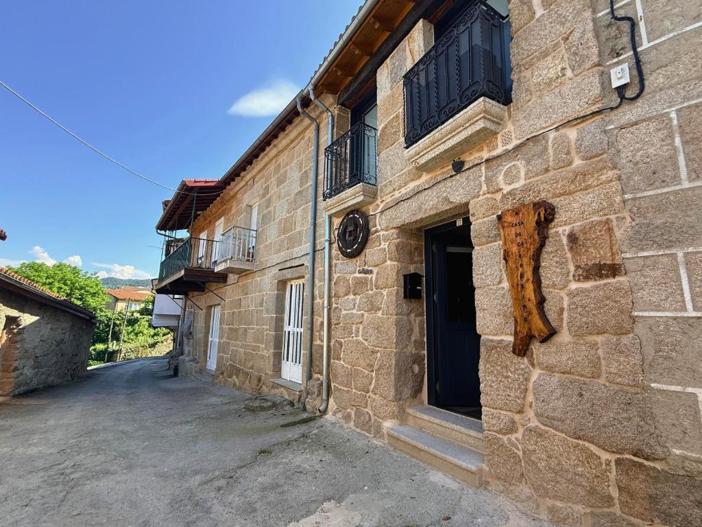 a stone building with a door and windows on it at YourHouse A Casa Do Cordeiro in Allariz