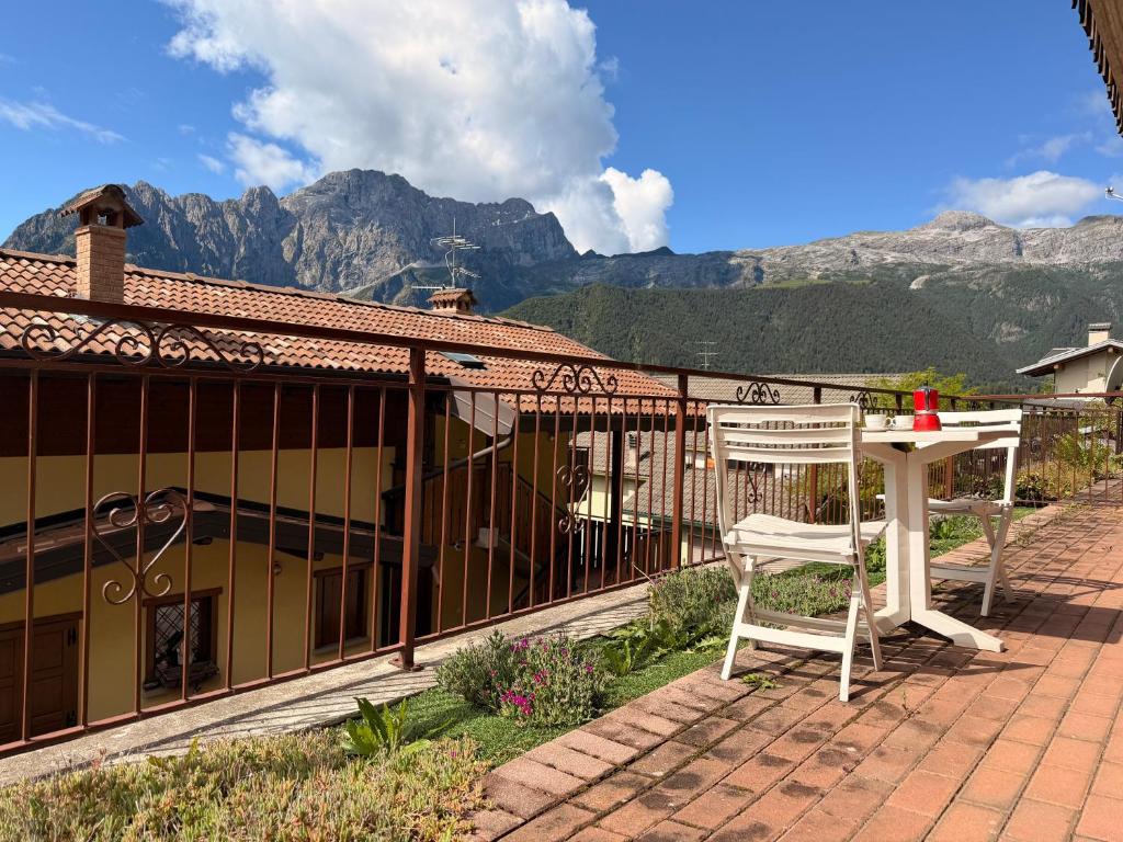 a table and a chair on a patio with mountains at Pieve Antica in Piazza