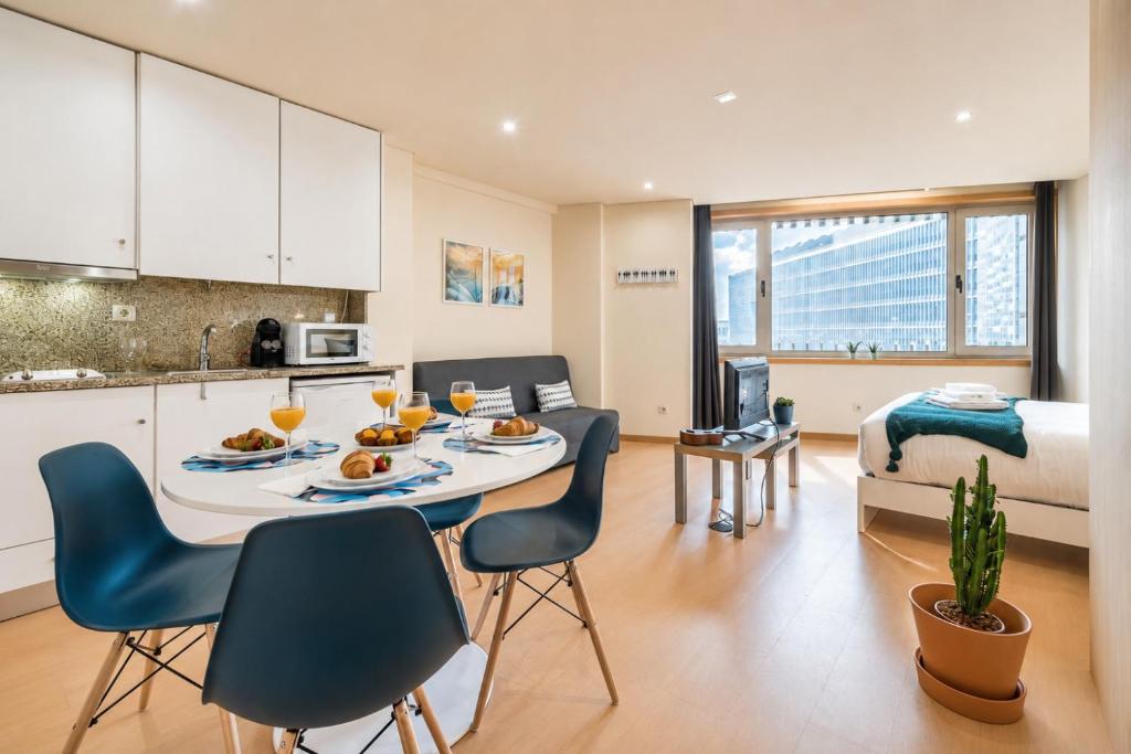 a kitchen and living room with a table with food on it at GuestReady - MusicHall in Porto