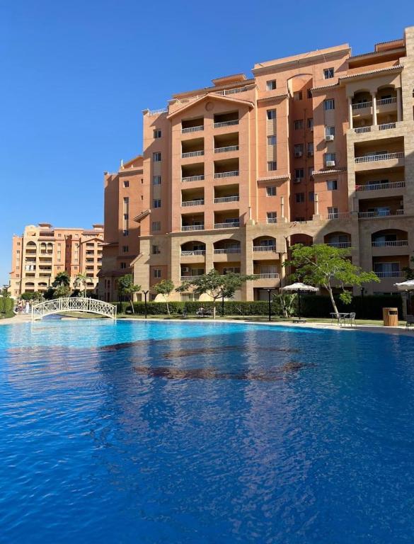 a large swimming pool in front of a large building at Marina Valley مارينا فالي in El Alamein