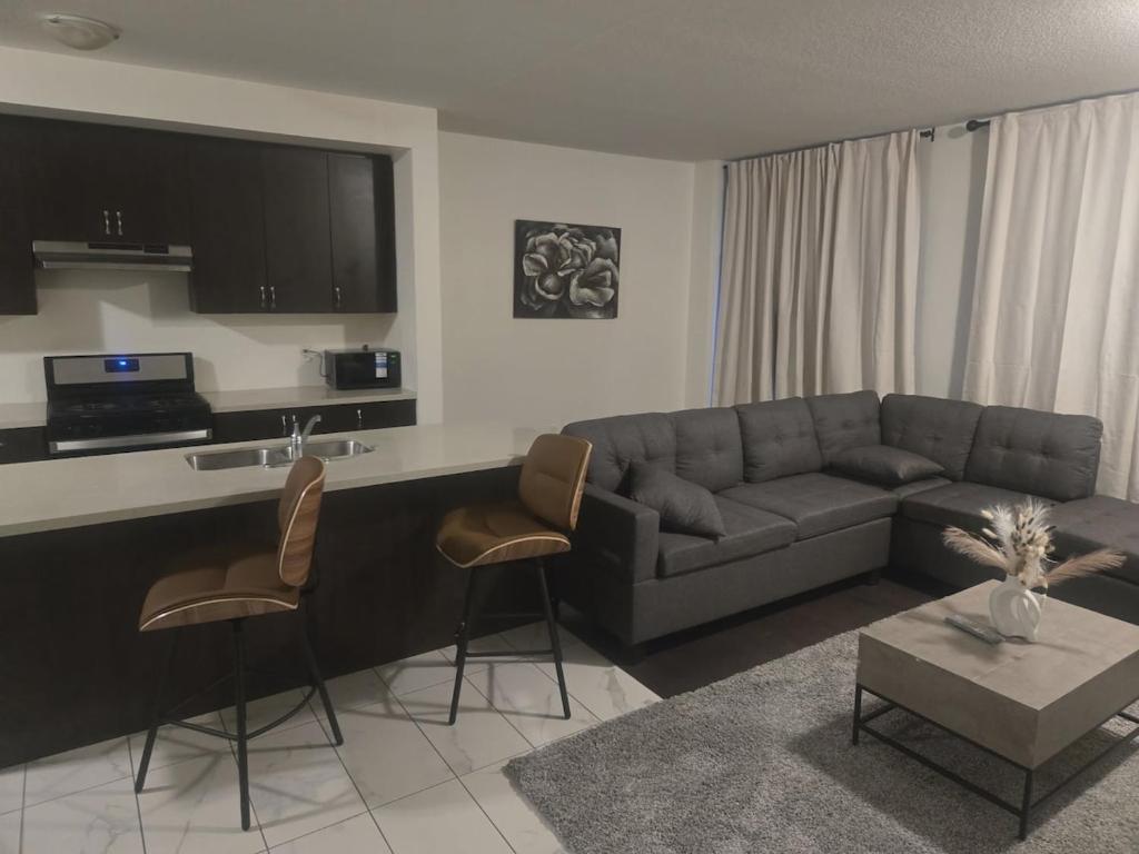 a living room with a couch and a table at Short stay and exploring the city in Markham