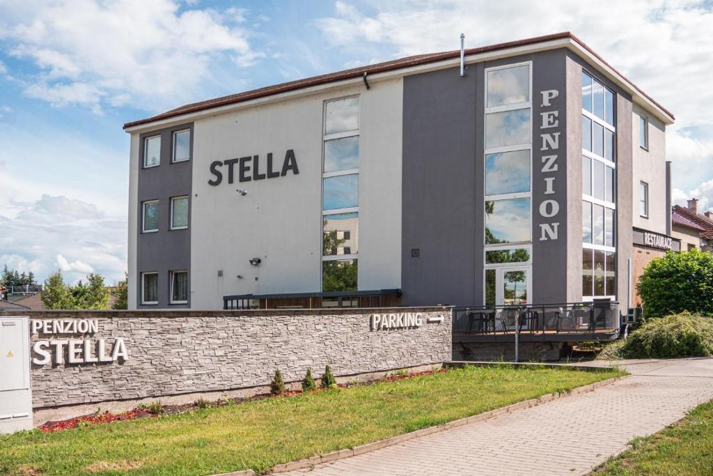 a building with a sign on the side of it at Penzion Stella in Prostějov
