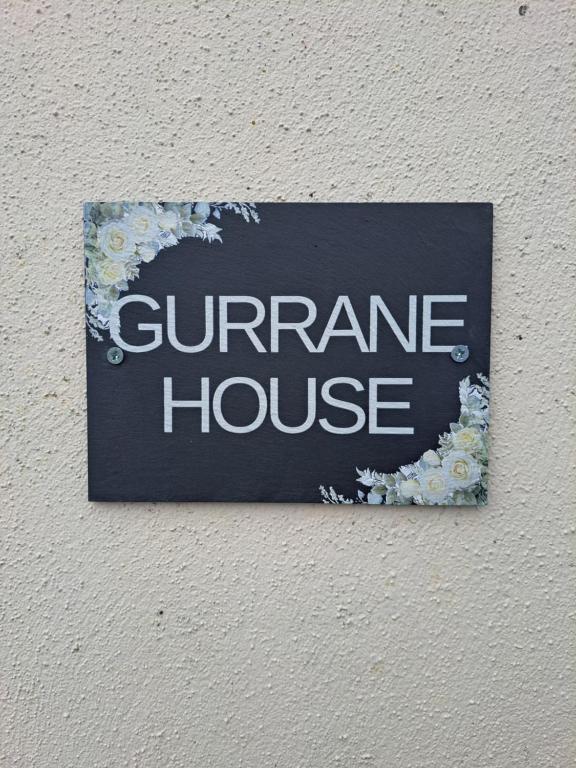 a sign on a wall that saysgarmite house at Gurrane House in Galway