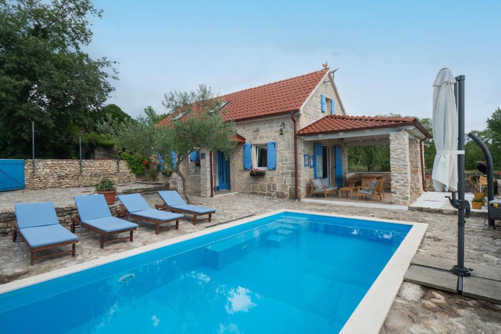 a villa with a swimming pool and a house at House Toma in Oklaj