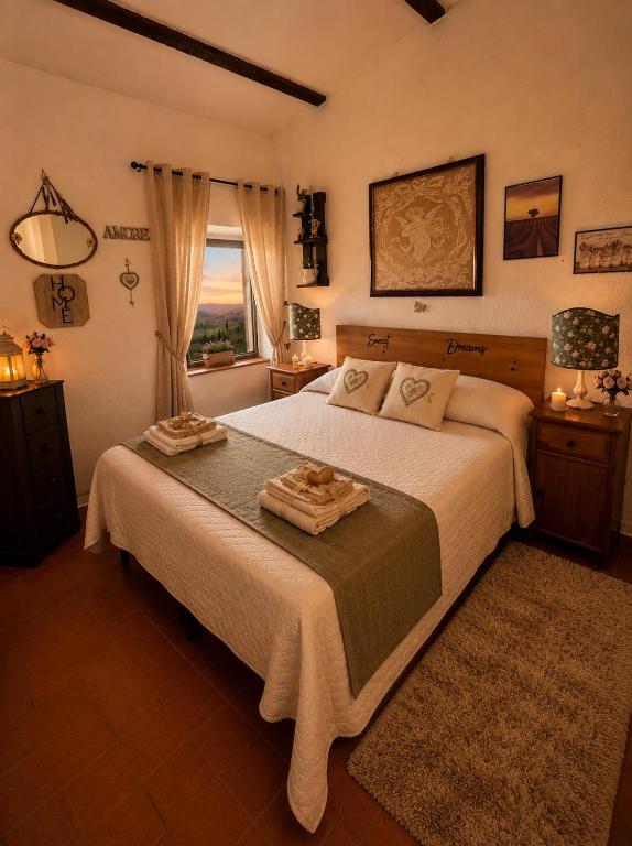a bedroom with a large bed and a window at Casa Amiata 2 in Montelaterone