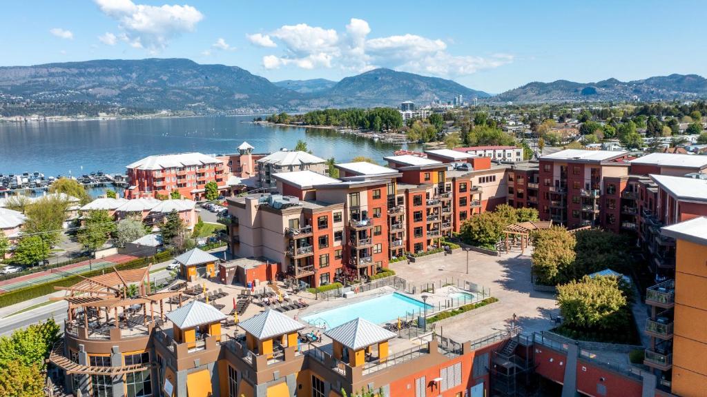 an aerial view of a city with a body of water at Playa Del Sol 2 Bdrm 649 w/ Mountain Views! in Kelowna