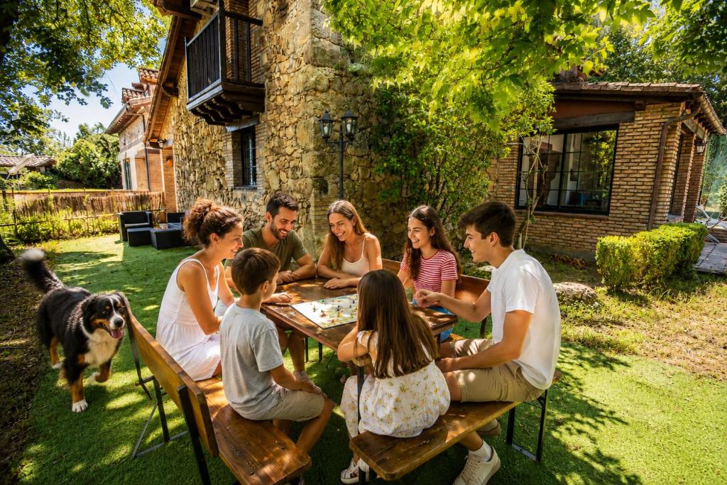 a group of people sitting around a table playing a game at Casa rural Paraje de Yuste in Cuacos de Yuste
