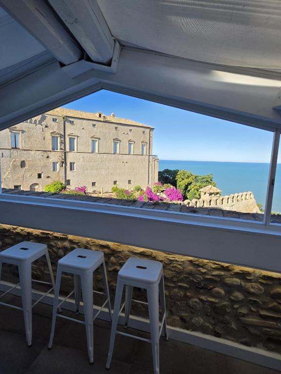 a view of a building from a window with stools at Residenza Amblingh in Vasto