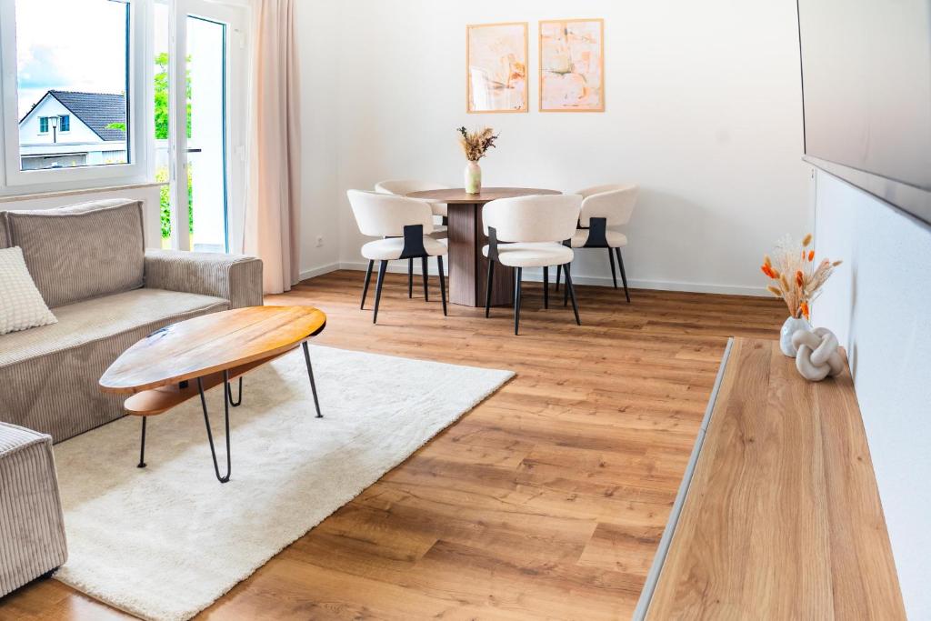 a living room with a table and a couch at Modern Stay in Lemgo
