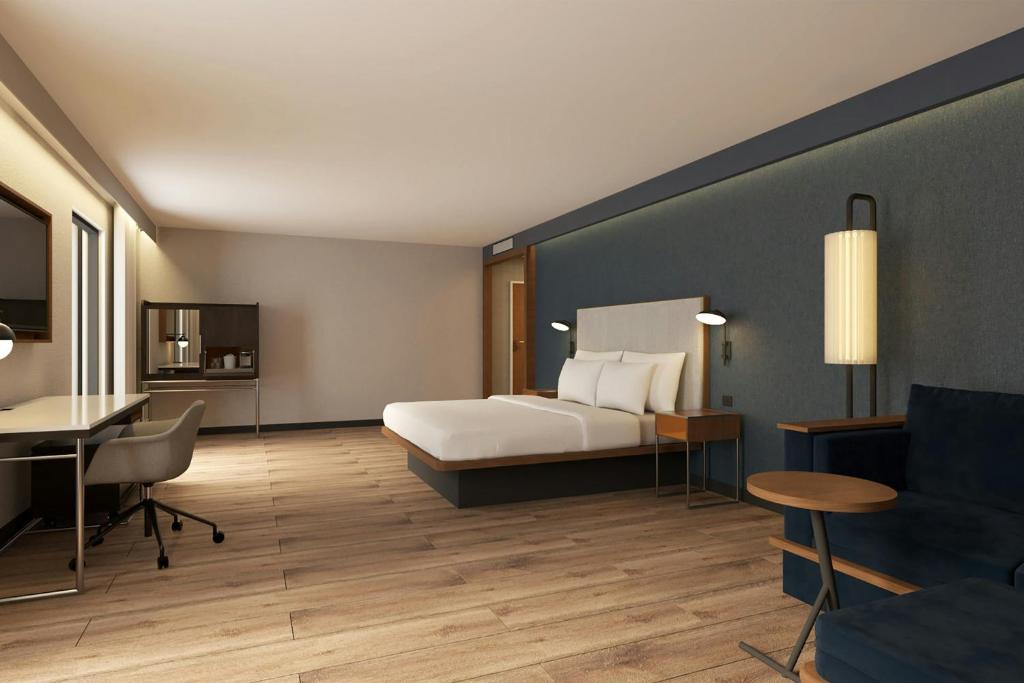 a hotel room with a bed and a desk at Courtyard by Marriott Torreón in Torreón