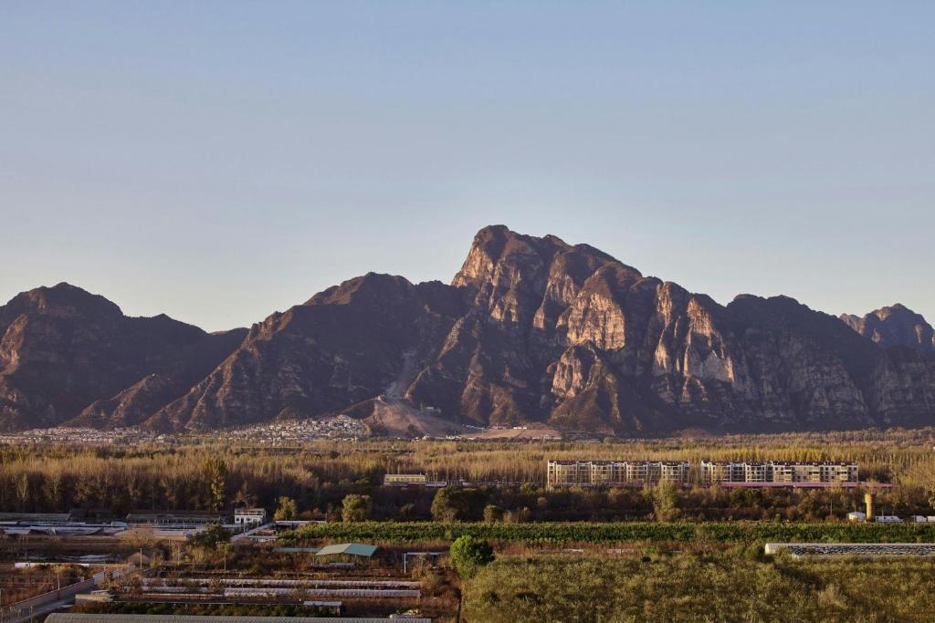 a mountain view of a city with trees and mountains at Beijing Marriott Hotel Yanqing in Yanqing