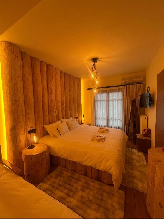 a bedroom with a large bed and a window at 4 MOUNTAIN HILLS in Megalo Chorio