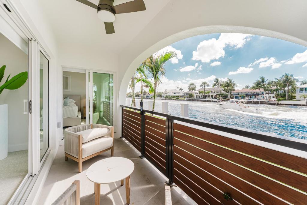 a room with a balcony with a view of the water at The Mizner - 2BR Waterfront Boca Suite in Boca Raton
