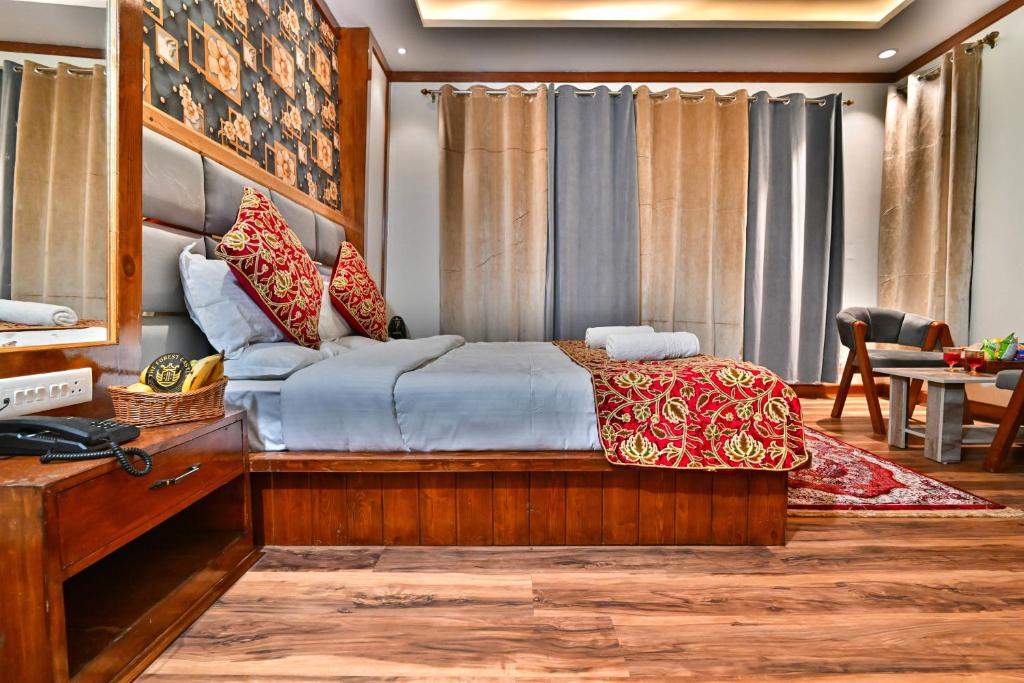 a bedroom with a bed and a desk and a table at The Forest Castle Resort in Pahalgām