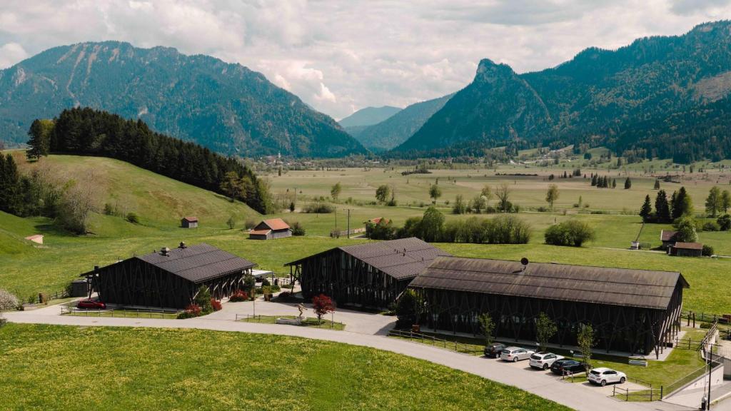 an aerial view of a farm with mountains in the background at Boutique-Hotel LARTOR in Unterammergau