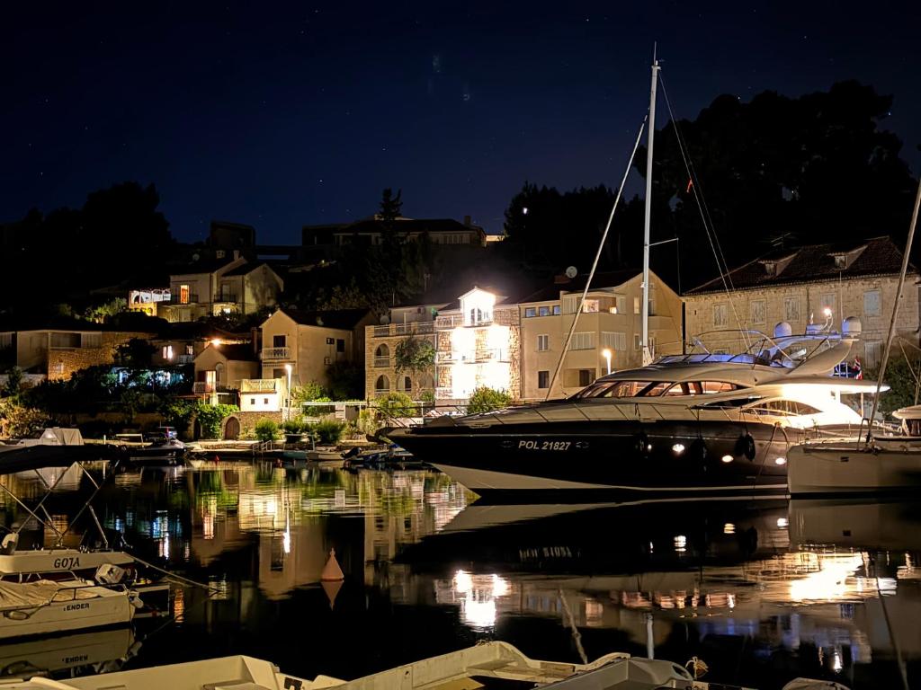 a boat is docked in a marina at night at Villa Aquiterra Bobovisca in Bobovišća